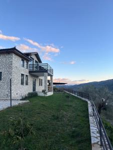 a house on top of a hill with a balcony at Villa Balliu in Berat +48 photos