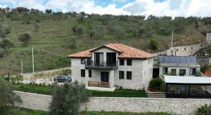 a house on a hill with a car parked at Villa Balliu in Berat