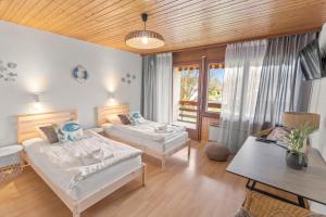 a living room with two beds and a table at Cari'Stay in Portalban- Dessous