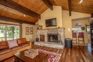 a living room with a couch and a fireplace at Coates By Hauserman Rentals in Tahoe City