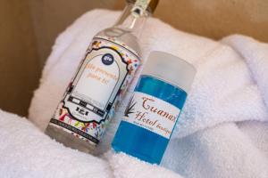 a bottle of sunscreen sitting on top of a towel at Cuanax hotel boutique tematico - Mineral de Pozos in Mineral de Pozos