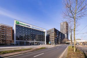 an empty street in a city with tall buildings at Holiday Inn Express Antwerpen City North by IHG in Antwerp