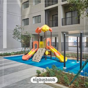 a playground with a slide in front of a building at Modera Suites at Parkland Condo TK in Phnom Penh