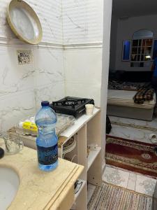 a bottle of water sitting on a counter in a bathroom at BRAZIL House in Muscat