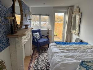 a bedroom with a bed and a mirror and a chair at Lakeside Haven in The Hyde