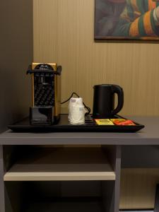 a tray with a coffee maker on top of a table at Il Tempio Luxury Rooms in Cosenza