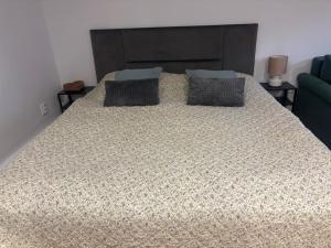 a large bed with two pillows on top of it at Apartment Ela Centre in Košice