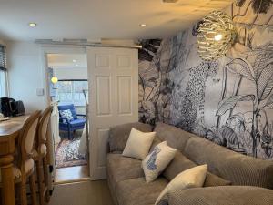 a living room with a couch and a wall mural at Lakeside Haven in The Hyde