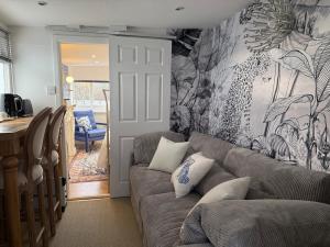a living room with a couch and a wall mural at Lakeside Haven in The Hyde