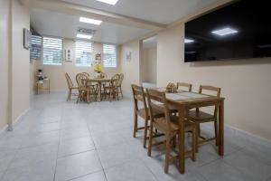 a dining room with a table and chairs at Blue Lodge in Manati