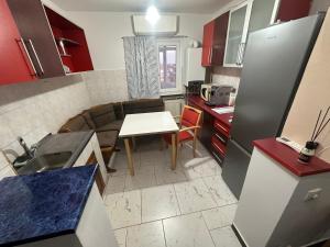 a small kitchen with a table and a couch in it at Coso in Filiaşi