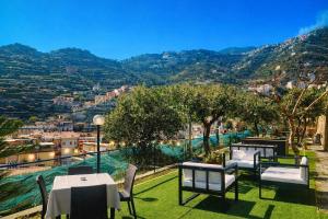 a view from a restaurant with tables and chairs at Eden Holiday in Minori +94 photos