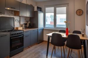 a kitchen with a table and a stove and a table and chairs at Naftininku in Mažeikiai