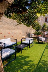 a group of benches sitting on the grass at Eden Holiday in Minori