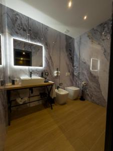 a bathroom with a sink and a toilet at Il Tempio Luxury Rooms in Cosenza
