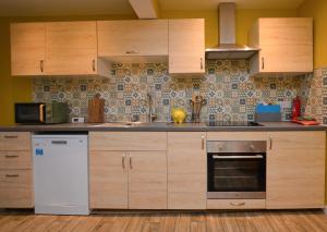 a kitchen with wooden cabinets and a white refrigerator at Dunmore Coastal Retreat in Dunoon