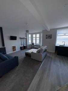 a large living room with a couch and a table at Skips in Largs