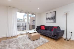 a living room with a couch and a large window at Orchard by UTDM in Bristol