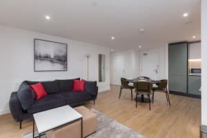 a living room with a couch and a table at Orchard by UTDM in Bristol