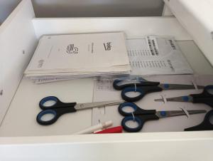 a box with several pairs of scissors in it at Loft Apartment with Parking in Poruba