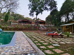 a backyard with a pool and a bench and a house at victory farms in Nadora
