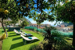 a group of benches sitting on the grass at Eden Holiday in Minori