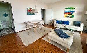 a living room with a couch and a table at Ferienwohnung C06 in Orselina