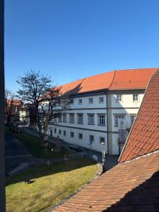 a large white building with a red roof at Henneberger Hof Wildlife in Münnerstadt