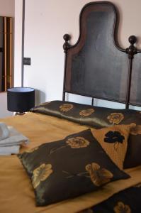 a bed with two pillows on top of it at Tenuta Roletto Cascina Guie in Cuceglio