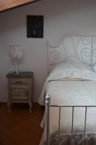 a bedroom with a bed and a table with a lamp at Tenuta Roletto Cascina Guie in Cuceglio