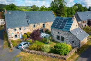 an aerial view of a stone house with a solar roof at Le Coudi in Saint-Pierre-le-Chastel