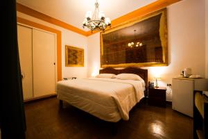 a bedroom with a bed and a chandelier at Casa Hacienda Majoro in Nazca +36 photos