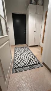 a room with a black door and a black and white rug at Best Rest Apartments in Narva-Jõesuu