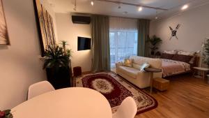 a living room with a couch and a bed at Best Rest Apartments in Narva-Jõesuu