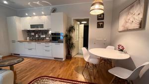a kitchen and living room with a table and chairs at Best Rest Apartments in Narva-Jõesuu
