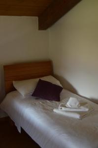 a bed with two towels and two pillows on it at Tenuta Roletto Cascina Guie in Cuceglio +9 photos