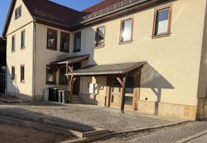 a building with awning on the side of it at Forrest Lounge Schweina in Bad Liebenstein