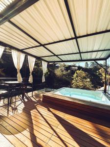 a patio with a hot tub and a table and chairs at Cabañas Ecologe BLESS in Chiquinquirá