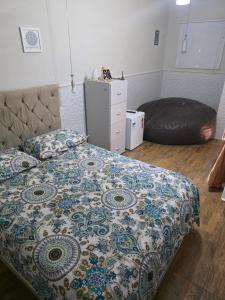 a bedroom with a bed and a bean bag chair at Quarto Ametista in Aracaju