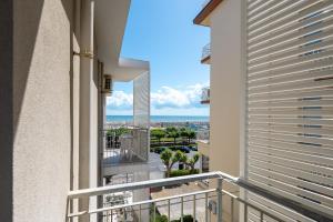 an apartment balcony with a view of the ocean at Hotel Rudy Cervia in Cervia
