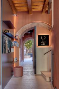 a hallway with an archway in a building with a tree at Zeno Suites in Verona