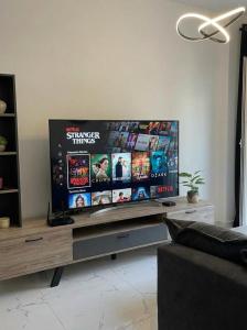 a large flat screen tv in a living room at White Port Suite in Ágios Rókkos