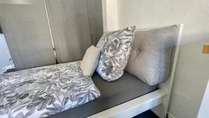 a bed with two pillows on top of it at Jans 4 Personen Work Apartment mit Küche P WLAN Code NRW Veltins Arena in Herten