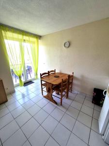 a room with a wooden table and a window at Gîte La Vallée RDC Neyrac-les-Bains in Meyras