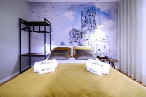 a bedroom with a large bed with two pillows at VILA DE PONTE GUEST HOUSE in Ponte de Lima