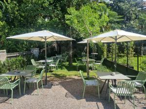 a group of tables and chairs with umbrellas at Ansitz Thierburg Suites in Merano
