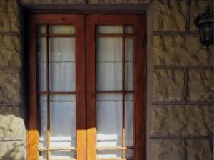 a door with glass windows on a stone building at Sandstone Escape Guesthouse in Ladybrand