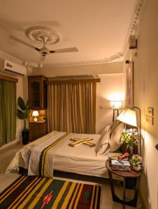 a hotel room with a bed and a table at 3 ac Bedroom in Dhaka