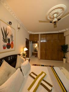 a living room with a couch and a ceiling fan at 3 ac Bedroom in Dhaka +1 photo
