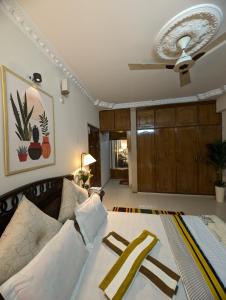 a bedroom with a bed and a ceiling fan at 3 ac Bedroom in Dhaka